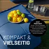A close-up of a blue beanbag with a bowl of lemons and limes on it, with a tray of drinks in the background. Produktbild-Vorschau