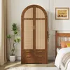 A wooden wardrobe with cane detailing in a bedroom setting. Produktbild-Vorschau