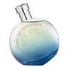 A round perfume bottle with a gradient of colors from yellow to blue, speckled with glitter and stars. Anteprima dell’immagine prodotto