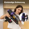 A woman is holding a cordless vacuum cleaner and emptying its contents into the air. Produktbild-Vorschau