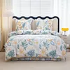 A bed with floral patterned bedding in a bedroom setting. Náhľad obrázku produktu