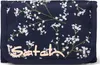 A close-up view of a navy blue wallet with a floral pattern and the brand name 'Satch' printed on it. Náhled obrázku produktu