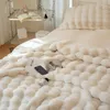 Cremefarbene Kunstfell-Decke mit strukturiertem Blasenmuster über einem Bett in einem Schlafzimmer Náhľad obrázku produktu