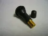 A black rubber tire valve with a gold threaded base and a black cap, lying on a light gray surface. Produktbild-Vorschau