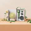 A green hair dryer and its accessories are displayed in an open gift box, with decorative elements like a rose and ribbon. Anteprima dell’immagine prodotto