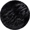 A round, black, shaggy rug on a white background. Anteprima dell’immagine prodotto