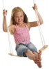 A young girl is sitting on a wooden swing. Náhľad obrázku produktu