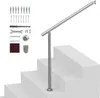 A silver handrail kit is shown assembled on a set of concrete stairs, with various mounting hardware and tools laid out to the left. Podgląd zdjęcia produktu