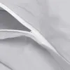 A close-up view of a light gray fabric with a white zipper. Produktbild-Vorschau