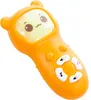 A close-up studio shot of an orange baby toy remote control with a cartoon face on the screen. Náhľad obrázku produktu