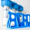 A close-up, slightly angled view of a blue plastic filter holder in the foreground, with three water filter housings in the background. Podgląd zdjęcia produktu