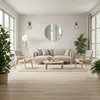 A bright and airy living room with a sofa, chairs, coffee table, and plants. Anteprima dell’immagine prodotto