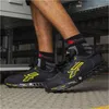 A person wearing safety shoes and socks. Produktbild-Vorschau