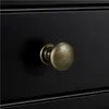 A close-up shot of a black drawer with a bronze knob. Podgląd zdjęcia produktu