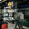 Workers in a factory setting with large machinery and materials. Produktbild-Vorschau