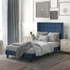 A bedroom scene with a blue upholstered bed. Produktbild-Vorschau