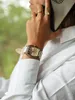A person is on the phone, wearing a watch. Náhled obrázku produktu