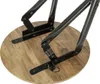 Close-up view of the underside of a round wooden table with black metal folding legs. Produktbild-Vorschau