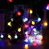 A string of colorful LED fairy lights wrapped around decorative objects, likely for home or party decoration. Produktbild-Vorschau