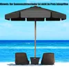A beach scene with two chairs and a large umbrella. Produktbild-Vorschau