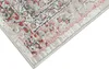 A close-up view of a rug with a distressed, vintage-inspired pattern. Produktbild-Vorschau
