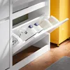 A white shoe cabinet with multiple shelves and shoes on display, next to a yellow cabinet. Náhľad obrázku produktu