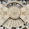 A close-up view of a wooden perpetual calendar with intricate carvings and numerical displays. Anteprima dell’immagine prodotto