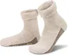 A pair of beige alpaca wool socks with brown accents and non-slip grips on the soles, presented on a white background. Produktbild-Vorschau