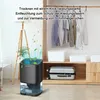 A dehumidifier is shown in a room with a closet full of clothes and luggage. Náhled obrázku produktu