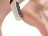 A close-up shot of an electric foot file being used on a person's heel. Voir les images du produit