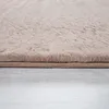 A close-up of a beige, high-pile rug with a textured surface, resting on a light gray wooden floor. Produktbild-Vorschau