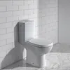 A white toilet in a bathroom with white subway tile walls and marble flooring. Anteprima dell’immagine prodotto