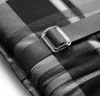 A close-up of a plaid cushion with a strap and buckle. Produktbild-Vorschau