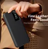 A hand holding a black leather flip case for a smartphone, with text overlay describing its features. Náhled obrázku produktu