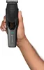 A hand holding a Remington hair clipper. Podgląd zdjęcia produktu