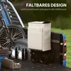The back of a pickup truck bed, loaded with a bicycle, tools, and a foldable garden cart with a beige fabric container. The scene is outdoors with grass in the background. Produktbild-Vorschau