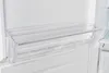 A clear plastic shelf inside a white refrigerator. Produktbild-Vorschau