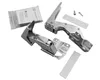Two silver metal hinges and a small bag of screws are laid out on a white background. The hinges appear to be for a cabinet or appliance door. There are also a few white strips, possibly for mounting or protection. Voir les images du produit