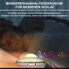 A person sleeping in bed with a sound machine on the nightstand. Produktbild-Vorschau