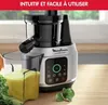 A close-up shot of a Moulinex juicer with a glass of juice next to it, on a wooden surface. Náhled obrázku produktu