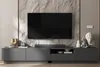 A modern living room setup featuring a TV stand and a large television mounted on a stone-effect wall. Produktbild-Vorschau