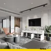 A modern living room with a white sideboard, TV, armchair, and coffee table. Voir les images du produit
