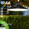A black solar pendant lamp hanging outdoors in the rain, with text overlays highlighting its features. Produktbild-Vorschau
