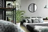 A bedroom scene with a bed, mirror, and plant. Produktbild-Vorschau