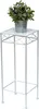 A white metal plant stand with a potted plant on top. Anteprima dell’immagine prodotto