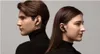 A man and a woman wearing black turtlenecks and black earbuds, facing away from each other. Podgląd zdjęcia produktu