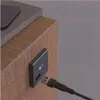 A close-up of a USB-C adapter plugged into a wooden surface, with a USB-A cable connected. Produktbild-Vorschau
