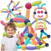 A young child gives a thumbs-up next to a collection of colorful magnetic building blocks. Náhled obrázku produktu