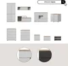 A collection of modern white furniture pieces with wood accents, displayed against a light gray and white background. Voir les images du produit