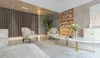 A modern living room with a sofa, chairs, coffee table, and bookshelf. Anteprima dell’immagine prodotto